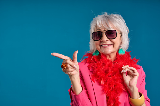Stylish Senior Woman Pointing with a Smile