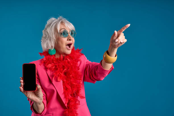 istock Excited senior showing off technology with smartphone and pointing out an offer 2083331167