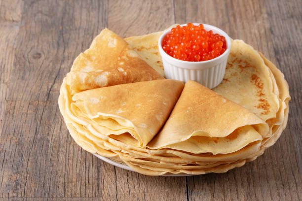 istock Pancakes with red caviar on a wooden table 2083332196