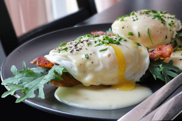 istock Eggs Benedict- toasted muffins, ham, poached eggs, delicious buttery hollandaise sauce 2083340823