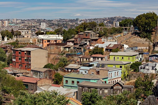 Valparaiso cityscape, colorful houses in Valparaiso, Chile. Old house with a spire against blue sky