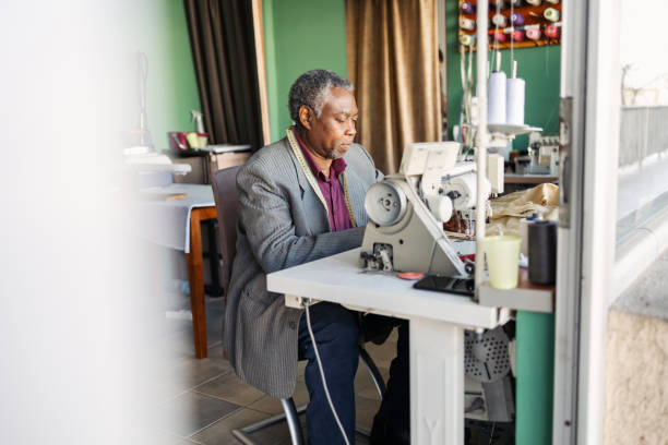 istock Latin senior man working as a tailor. He is working in the small tailoring shop. 2083375533