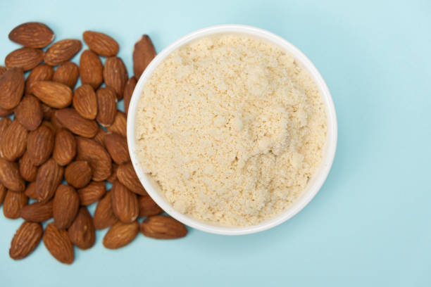 istock Almond flour and almonds on a blue background top view 2083375556