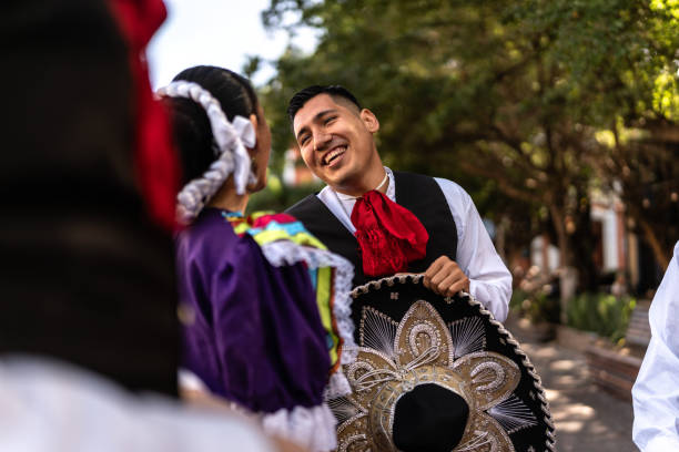 istock Traditional mariachi talking with mexican dancer outdoors 2083392887