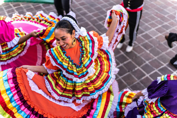 mid adult woman dancing in traditional festival at public park - mexicano imagens e fotografias de stock
