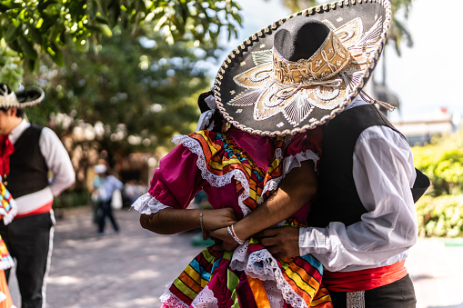 Young Panamanian couple dancing during the Tournament of Roses in Pasadena. The woman is wearing a traditional Panamanian folklore dress or 'Pollera' and jewelry.