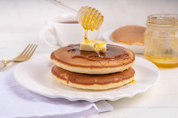 istock Pancakes with butter and honey or maple syrup drizzles 2083399466