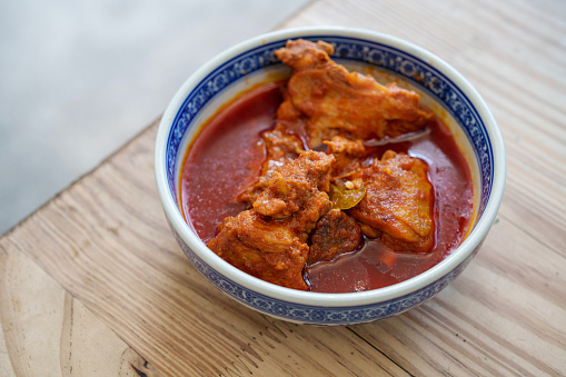 Kapitan chicken curry is a richer, drier, thicker version of the standard chicken curry, and is immediately recognizable by its distinct Southeast Asian flavor from local spices & herbs such as galangal, candlenuts, lemongrass, and kaffir lime leaves.