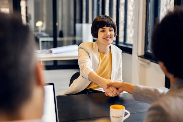 istock Business partners shaking hands at the office. 2083403158