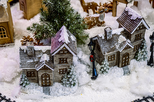 miniature scenery of a christmas village with lighted decorations. christmas scenery banner, peaceful winter houses
