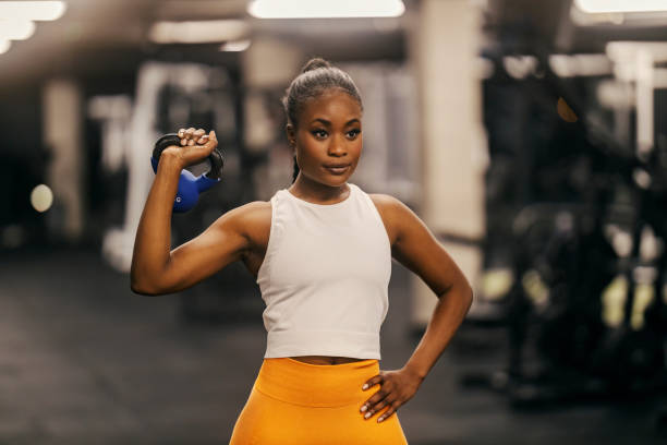 istock A young black strong sportswoman posing with kettlebell at gym. 2083409039