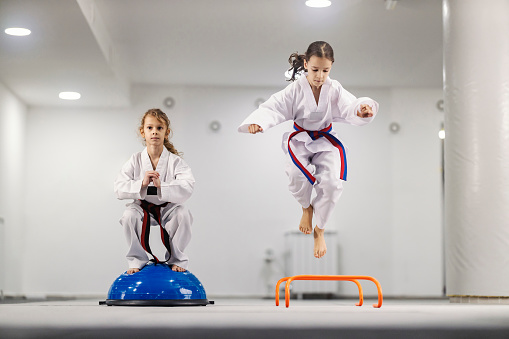 Taekwondo girls having balance practice at martial art school class.