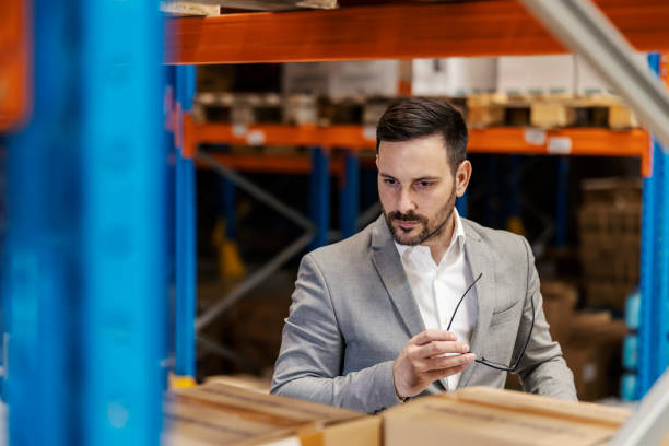 istock A serious manager is checking on goods in warehouse. 2083414881