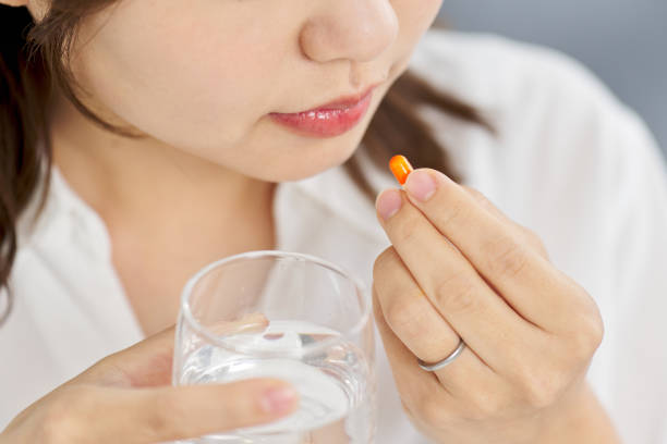 istock Asian woman drinking capsule medicine 2083426865