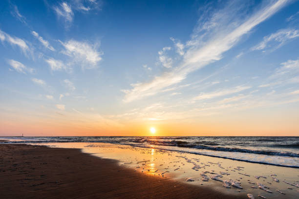 A minimalist beach scene with an empty sea and clear horizon, ideal as a background with ample copy space. The calm water and open sky create a peaceful, versatile backdrop. 20
