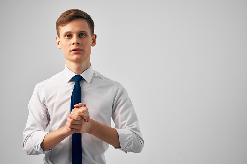 man in white shirt with tie gesturing with hands success emotions self-confidence. High quality photo
