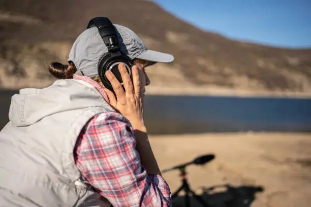 Sustainability practices. Woman does field-based studies using AI driven ecoacoustic approaches in bioacoustics research.