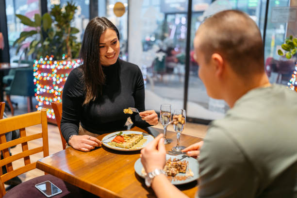 young couple eating belgian waffles and drinking champagne in a pub - waffle eating meal food and drink zdjęcia i obrazy z banku zdjęć