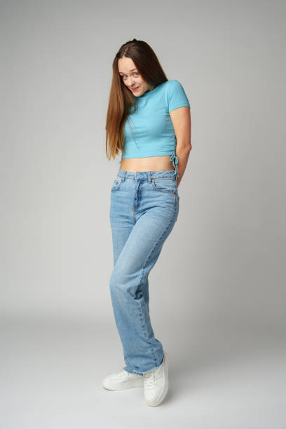 istock Young woman feeling uncomfortable and shy on gray background 2083483938