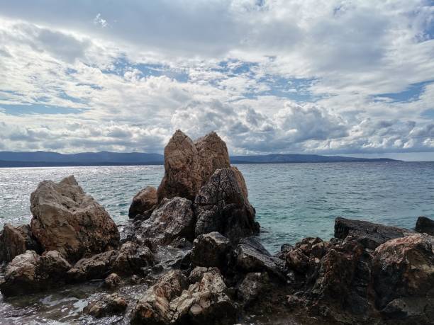 istock Huge rocks on the coastline with clear sky 2083493436