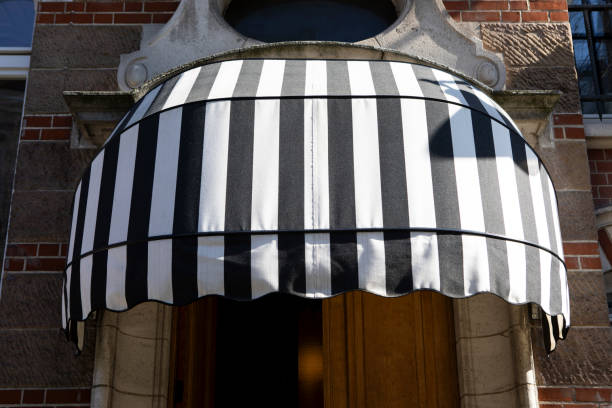istock Black and white striped canopy above a doorway 2083494065