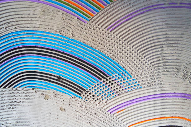 Textured multicolored semicircles on a cement wall. Decorative rough putty