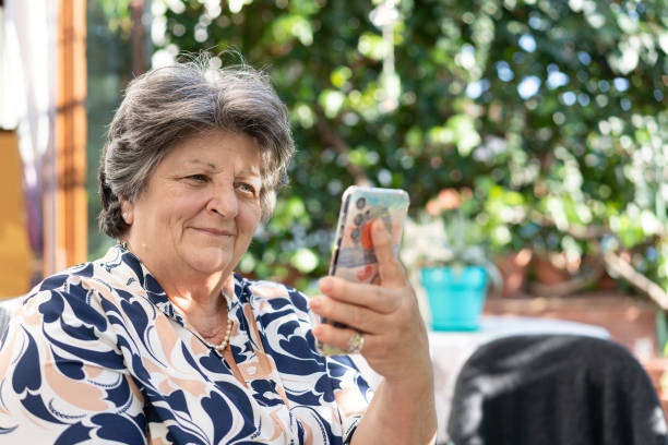 istock Senior woman making a video call on smartphone 2083532064
