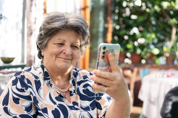 istock Senior woman making a video call on smartphone 2083532065