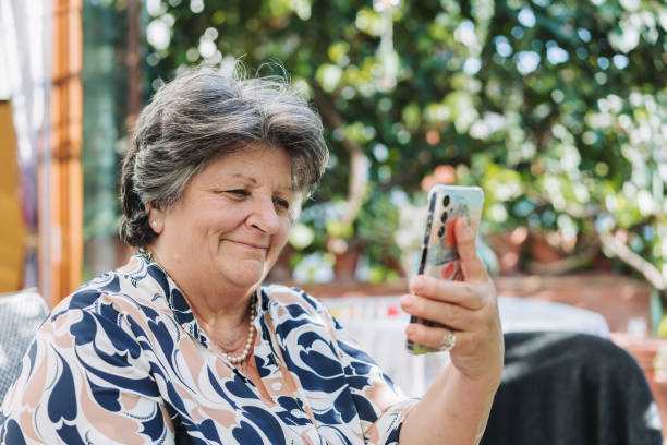 istock Senior woman making a video call on smartphone 2083532573