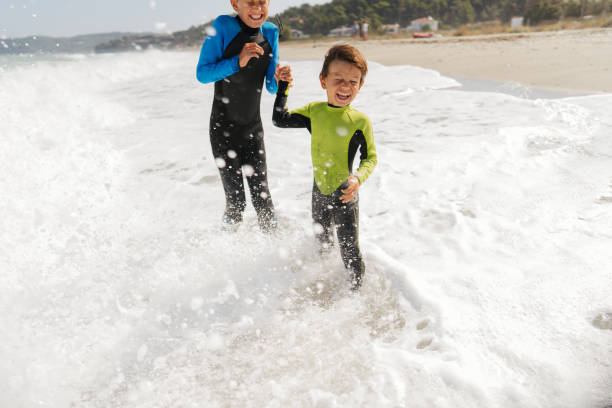 istock Young boys playing with the ocean waves 2083537919