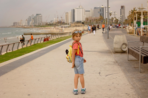 European tourist family with children, visiting Tel Aviv, Israel, enjoying day walk in the city