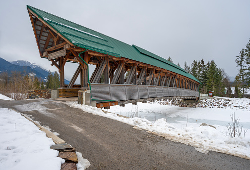 Pedestrian pathway and covered bridge over the Kicking Horse River in the town of Golden, British Columbia, Canada