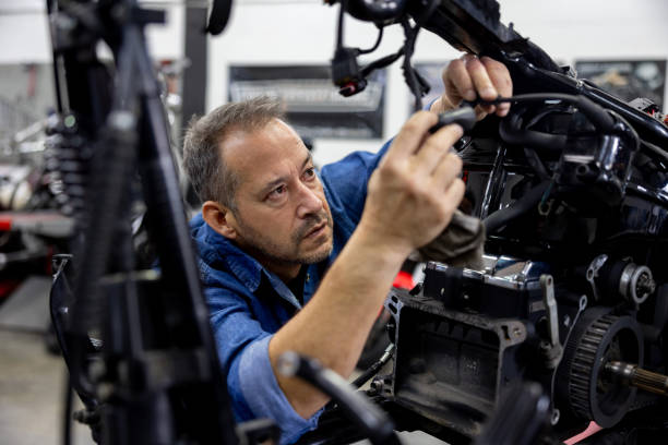 Maintenance engineer fixing a motorcycle at an auto repair shop
