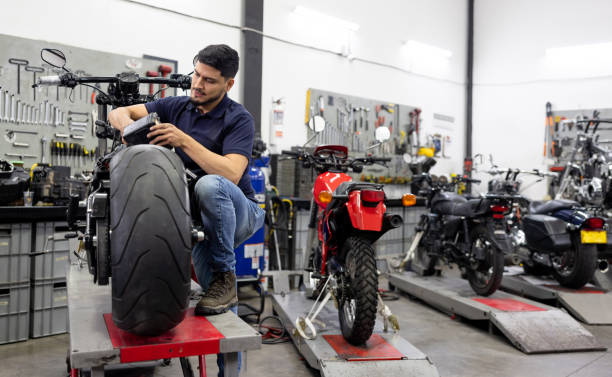 istock Engineer installing the battery on a motorcycle at a repair shop 2083542222