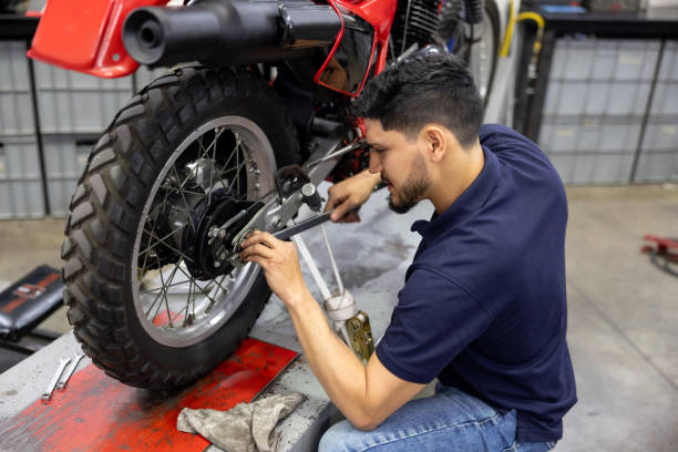 istock Mechanic installing a tire on a motorcycle at a garage 2083542238
