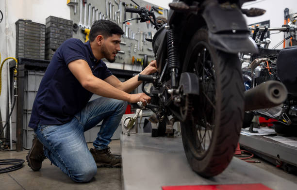 istock Mechanic repairing a motorcycle at a garage 2083542249