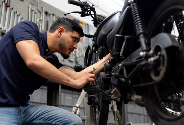 istock Mechanic repairing a motorcycle at a garage 2083542252