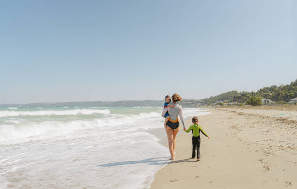 istock Mom and her little surfers 2083546662