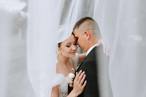 Couple, love or wedding dress veil after marriage event, ceremony or union in nature environment. Smile, happy or trust man or woman or bride and groom bonding after romance celebration by water lake