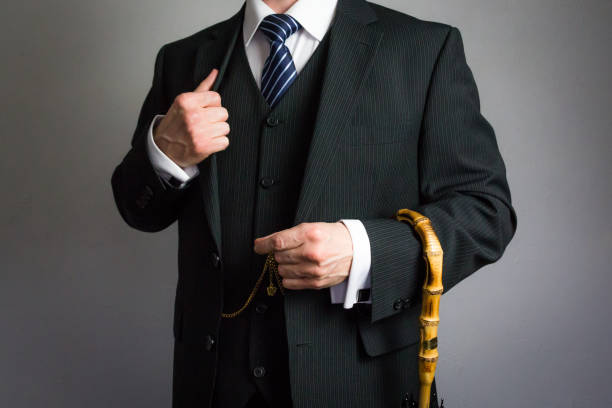 istock Stylish British Gentleman in Suit Holding Umbrella 2083600650