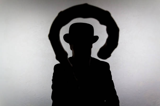 istock Silhouette of British Gentleman Holding Umbrella 2083601196