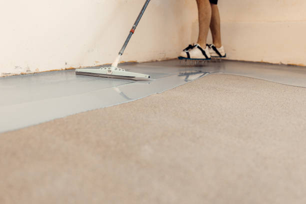 istock A construction worker apply grey epoxy resin in an industrial hall 2083614443