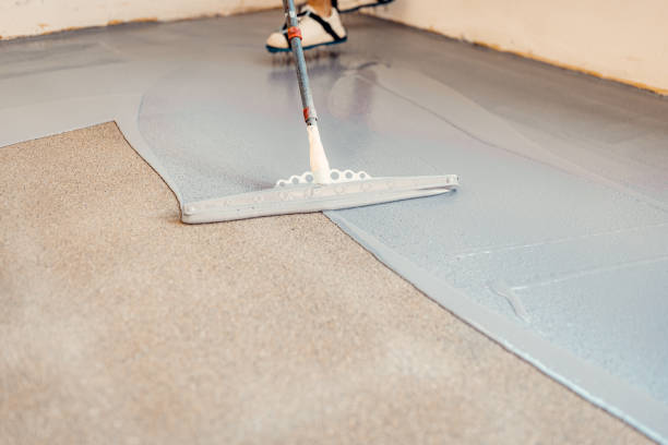 istock A construction worker apply grey epoxy resin in an industrial hall 2083614969