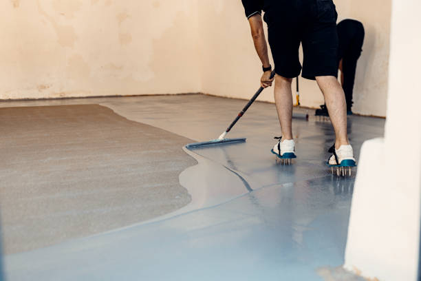 istock A construction worker apply grey epoxy resin in an industrial hall 2083614984
