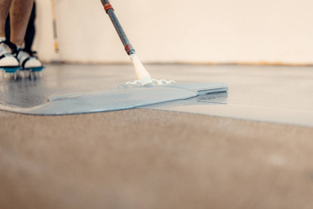 istock A construction worker apply grey epoxy resin in an industrial hall 2083614985