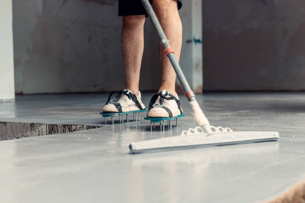 istock A construction worker apply grey epoxy resin in an industrial hall 2083619263