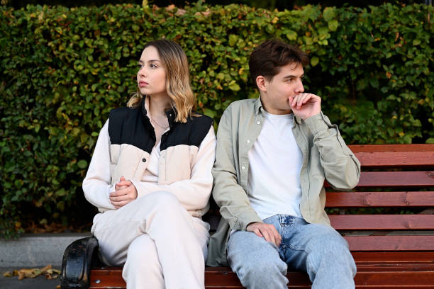 istock A couple sits on a park bench and looks away from each other 2083637200