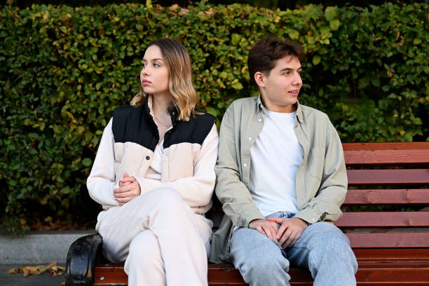istock A couple sits on a park bench and looks away from each other 2083637204