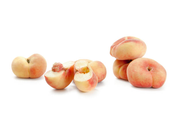 istock Half and several whole saturn peaches or flat peaches isolated on white background with clipping path. 2083642445