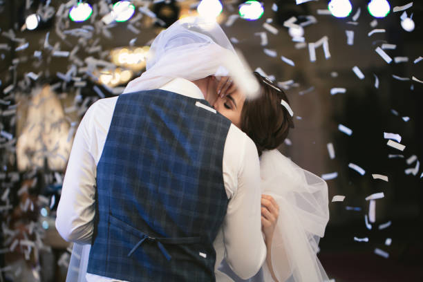 Happy wedding couple performs the first dance in a restaurant. Romantic moments.